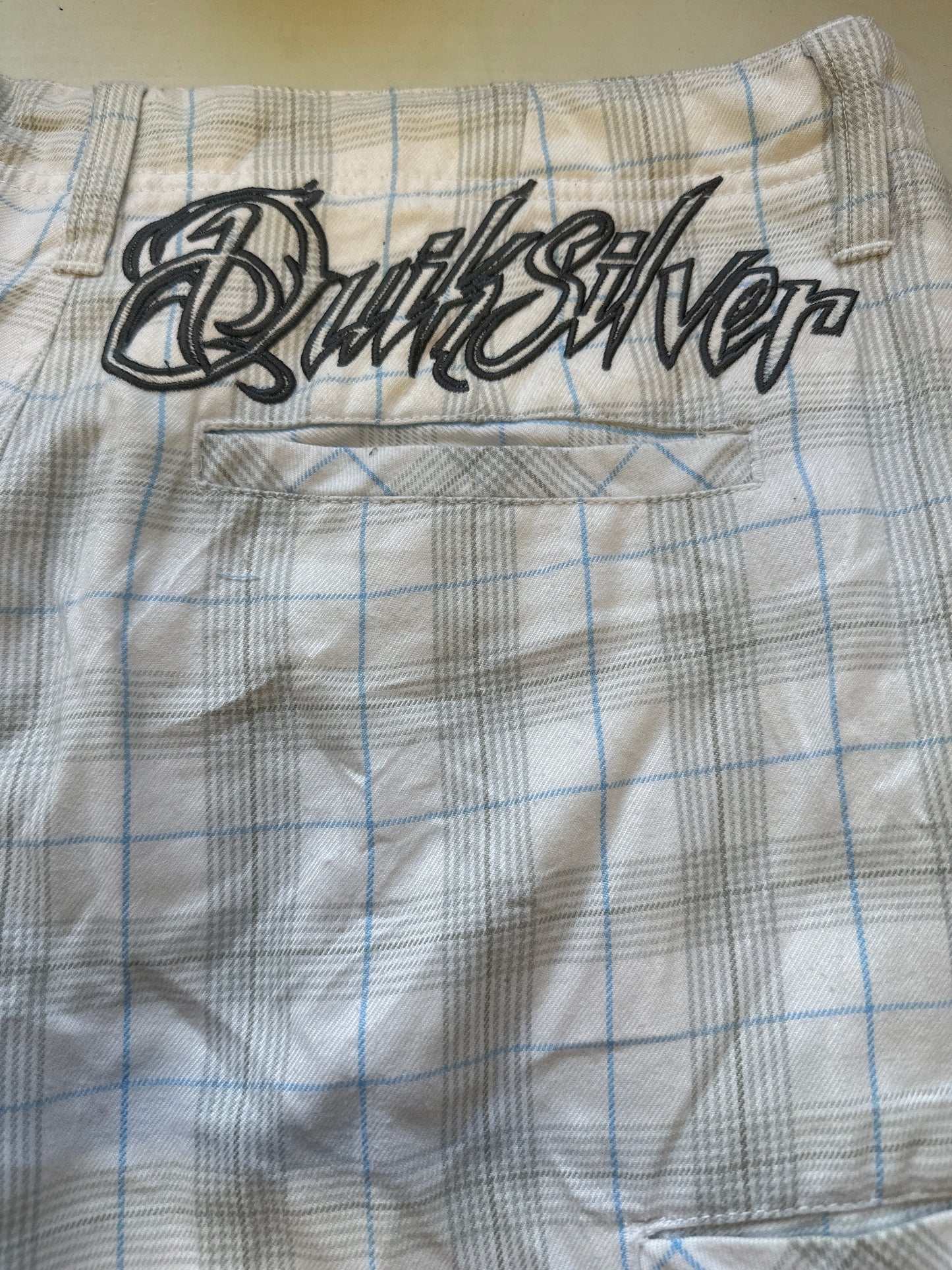 white checkered quiksilver long shorts