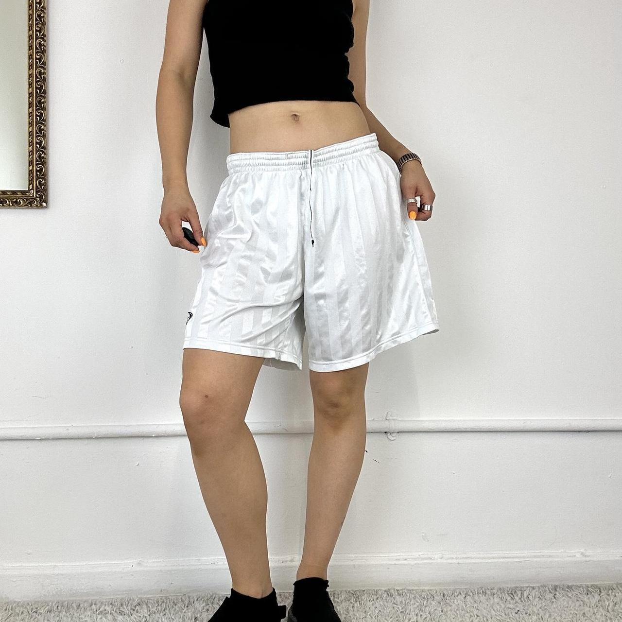 baggy white Nike track shorts