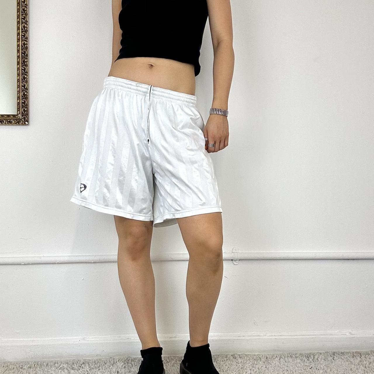 baggy white Nike track shorts