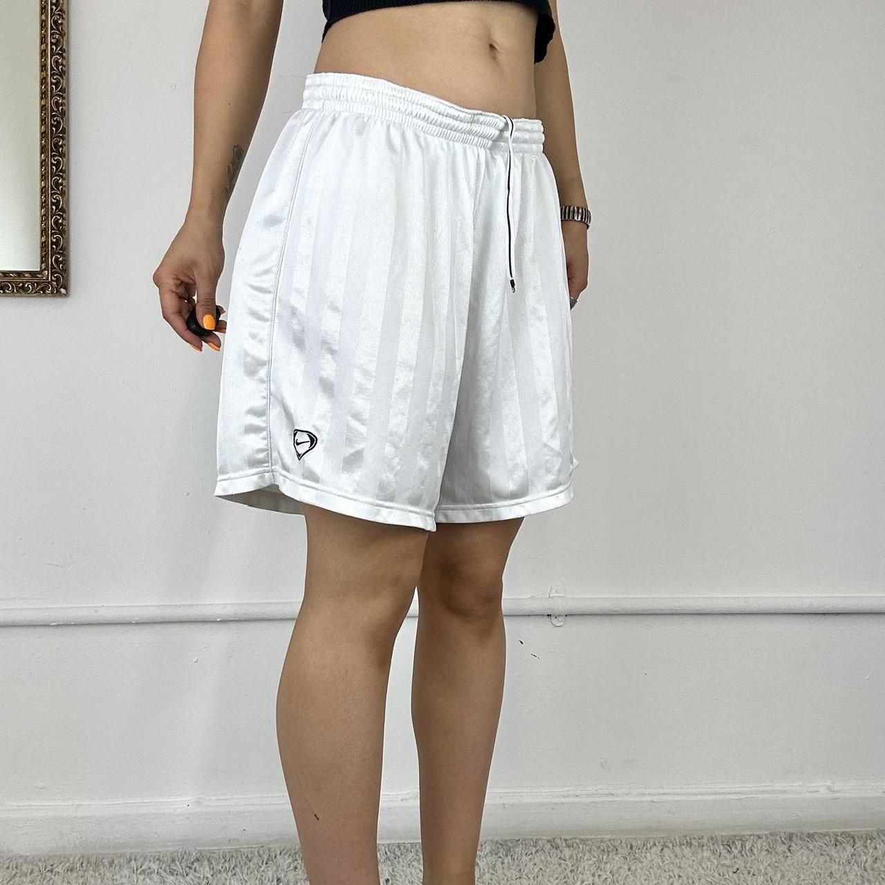 baggy white Nike track shorts